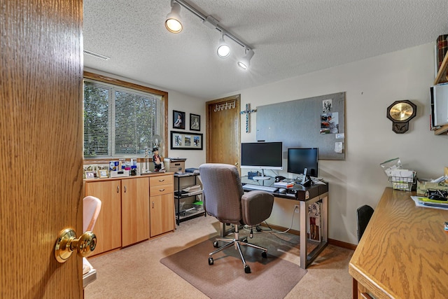 office area with light colored carpet and a textured ceiling