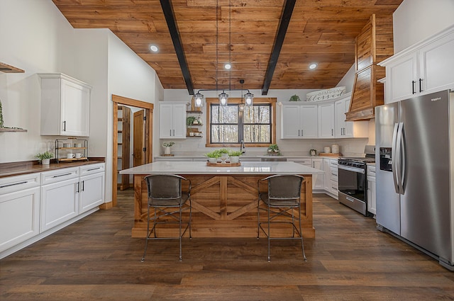 kitchen featuring appliances with stainless steel finishes, wooden ceiling, open shelves, a breakfast bar area, and white cabinets