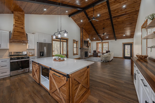 kitchen with appliances with stainless steel finishes, wooden ceiling, ceiling fan, high vaulted ceiling, and dark wood finished floors