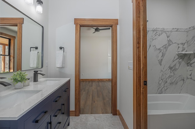 full bathroom featuring a tub and double vanity