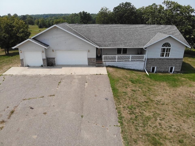 ranch-style home with a front yard, a porch, a garage, and aphalt driveway