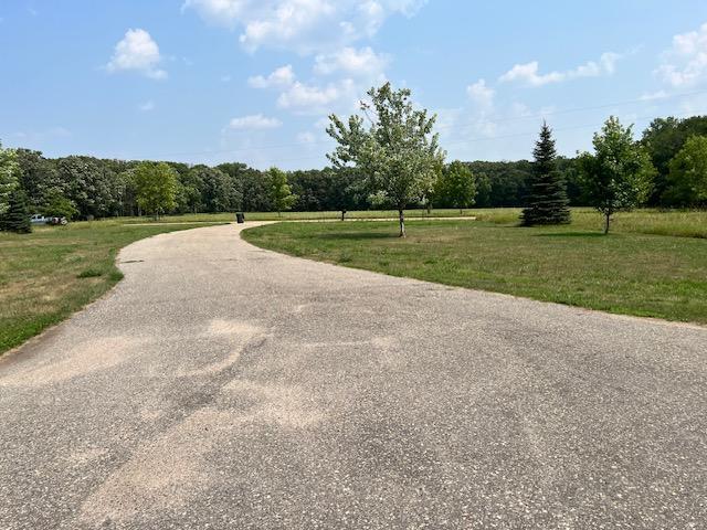 view of property's community featuring a yard and a forest view