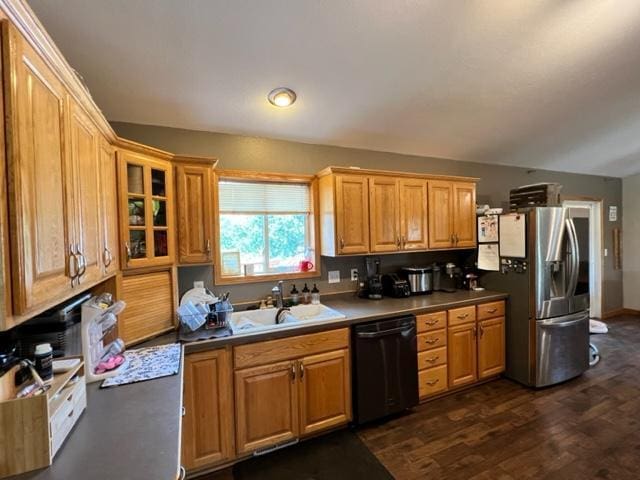 kitchen featuring a sink, stainless steel refrigerator with ice dispenser, dark wood finished floors, dishwasher, and glass insert cabinets