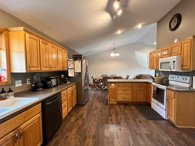 kitchen with a peninsula, lofted ceiling, white appliances, dark wood-type flooring, and hanging light fixtures