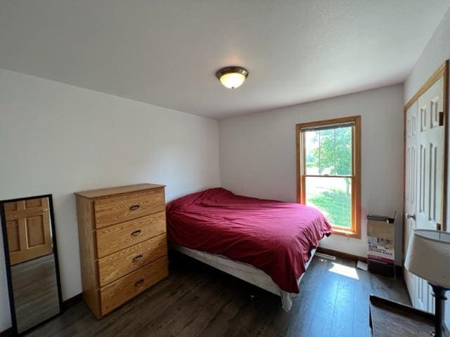 bedroom with dark wood finished floors