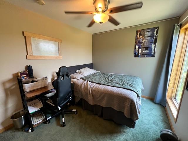 bedroom featuring ceiling fan and carpet floors