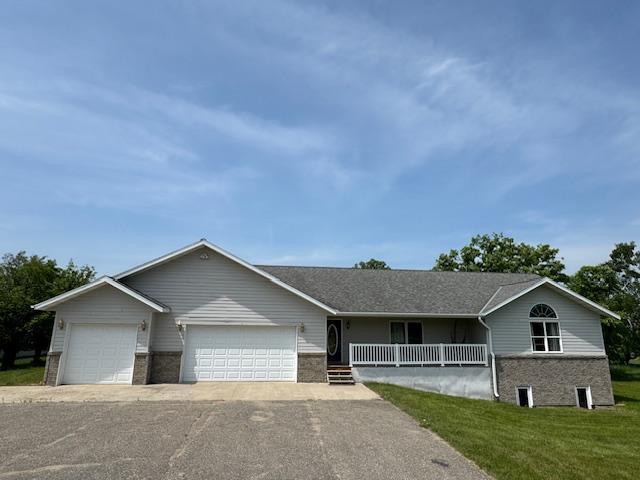 18851 121st Ave, Leaf River Twp, MN 56482 - ranch-style house with a porch, a front yard, and an attached garage