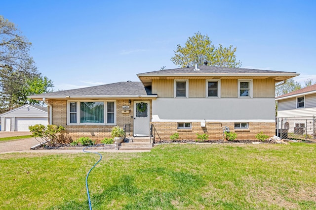 split level home with brick siding, an outbuilding, and a detached garage