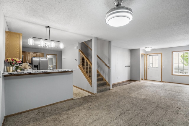 7327 Kalland Cir NE Unit 28, Otsego, MN 55301 - unfurnished living room with a textured ceiling, light colored carpet, baseboards, and stairway