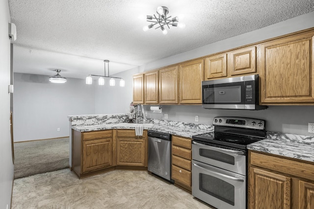 7327 Kalland Cir NE Unit 28, Otsego, MN 55301 - kitchen featuring stainless steel appliances, a peninsula, a textured ceiling, light stone counters, and brown cabinetry