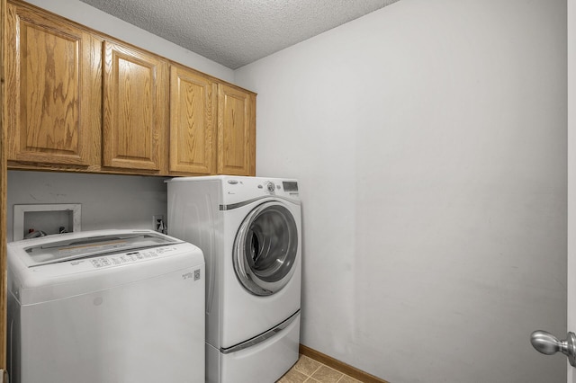 7327 Kalland Cir NE Unit 28, Otsego, MN 55301 - laundry area with cabinet space, washing machine and clothes dryer, a textured ceiling, and baseboards