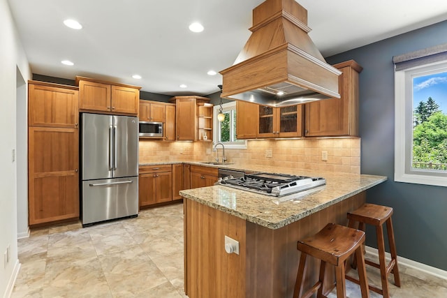 5820 139th St W, Apple Valley, MN 55124 - kitchen featuring appliances with stainless steel finishes, custom range hood, a peninsula, brown cabinetry, and open shelves