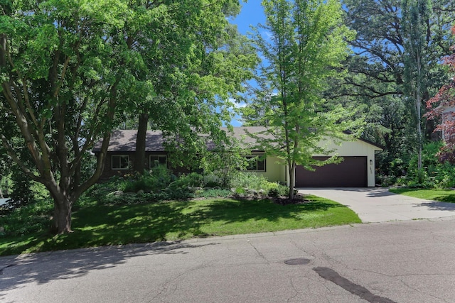 5820 139th St W, Apple Valley, MN 55124 - view of property hidden behind natural elements featuring concrete driveway, a garage, and a front lawn