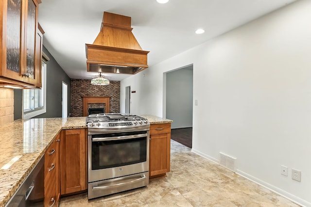 5820 139th St W, Apple Valley, MN 55124 - kitchen with stainless steel gas range, a fireplace, a peninsula, brown cabinetry, and recessed lighting