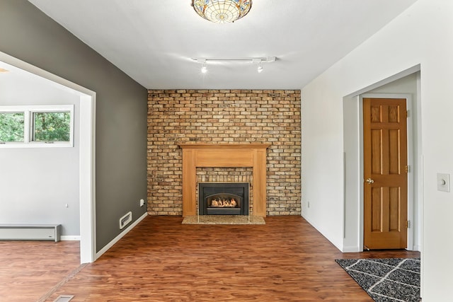 5820 139th St W, Apple Valley, MN 55124 - unfurnished living room featuring a baseboard heating unit, wood finished floors, and a fireplace