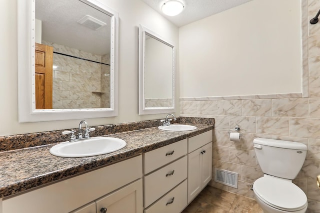 5820 139th St W, Apple Valley, MN 55124 - bathroom with double vanity, tiled shower, and a textured ceiling