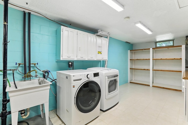 5820 139th St W, Apple Valley, MN 55124 - washroom with separate washer and dryer, cabinet space, concrete block wall, and a textured ceiling