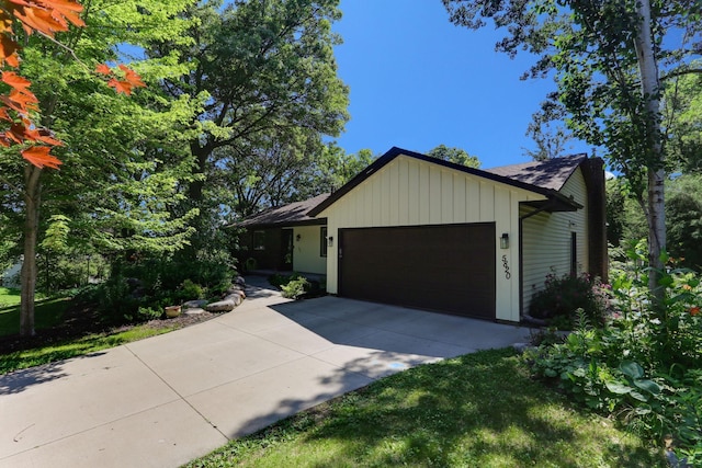 5820 139th St W, Apple Valley, MN 55124 - view of front of home featuring a garage, driveway, roof with shingles, and board and batten siding