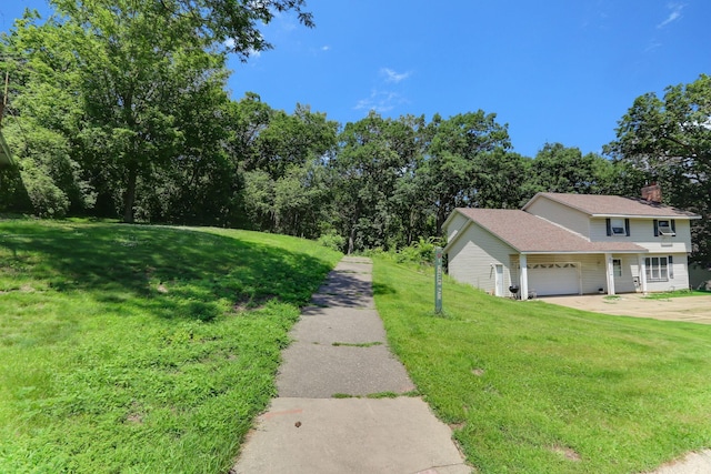 5820 139th St W, Apple Valley, MN 55124 - view of green lawn featuring a garage and driveway