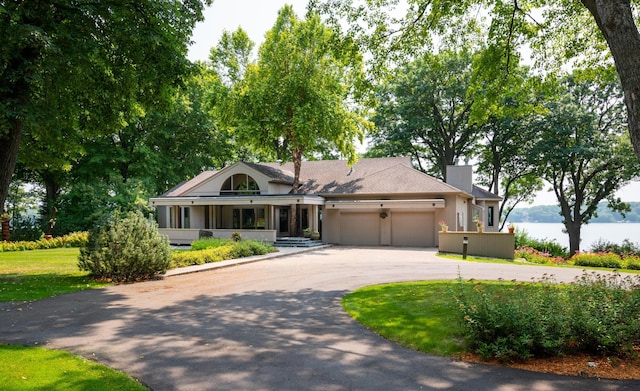 9002 Riley Lake Rd, Eden Prairie, MN 55347 - single story home with a garage, asphalt driveway, a front lawn, and a chimney