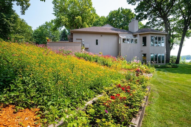 9002 Riley Lake Rd, Eden Prairie, MN 55347 - rear view of house with a chimney and a yard
