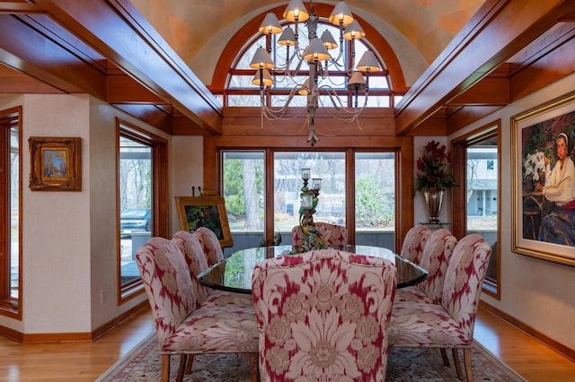 9002 Riley Lake Rd, Eden Prairie, MN 55347 - dining area with a chandelier, light wood finished floors, baseboards, and lofted ceiling