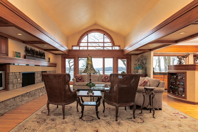 9002 Riley Lake Rd, Eden Prairie, MN 55347 - living room with a stone fireplace, vaulted ceiling, wood finished floors, and a water view