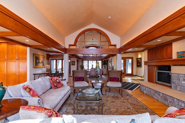 9002 Riley Lake Rd, Eden Prairie, MN 55347 - living area with wood finished floors, a stone fireplace, and lofted ceiling