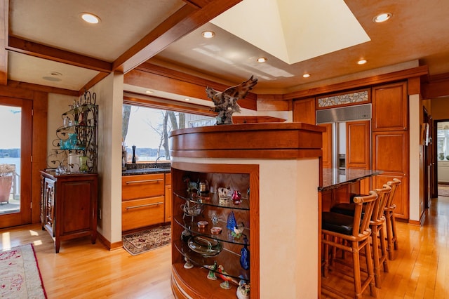 9002 Riley Lake Rd, Eden Prairie, MN 55347 - bar featuring light wood-style floors, recessed lighting, a skylight, and baseboards