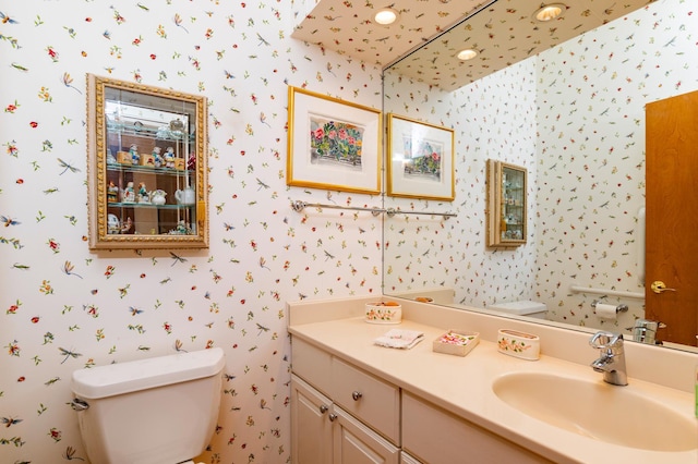 9002 Riley Lake Rd, Eden Prairie, MN 55347 - bathroom with wallpapered walls, toilet, and vanity