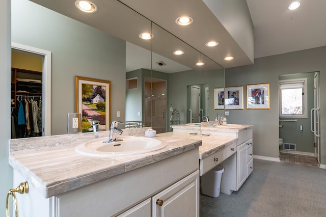 9002 Riley Lake Rd, Eden Prairie, MN 55347 - bathroom featuring a shower stall, vanity, recessed lighting, baseboards, and toilet