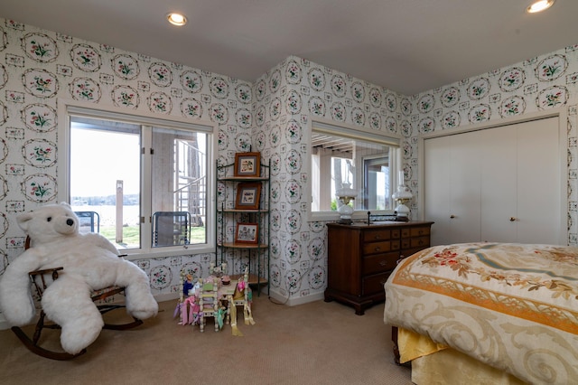9002 Riley Lake Rd, Eden Prairie, MN 55347 - bedroom with wallpapered walls, light colored carpet, recessed lighting, baseboards, and a closet