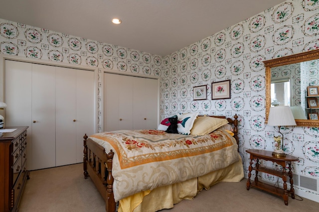 9002 Riley Lake Rd, Eden Prairie, MN 55347 - bedroom with multiple closets, wallpapered walls, light carpet, and recessed lighting