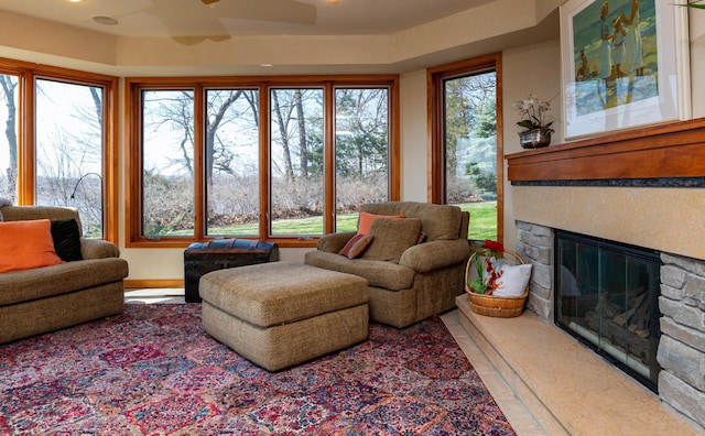 9002 Riley Lake Rd, Eden Prairie, MN 55347 - living room featuring ceiling fan, a stone fireplace, and healthy amount of natural light