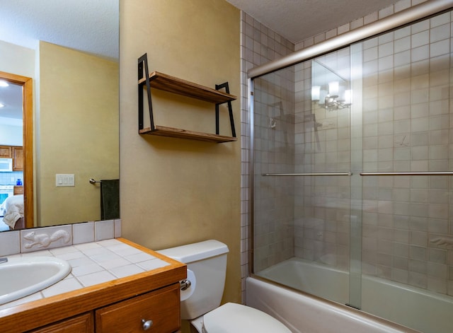 9002 Riley Lake Rd, Eden Prairie, MN 55347 - full bathroom with toilet, vanity, bath / shower combo with glass door, a textured ceiling, and connected bathroom