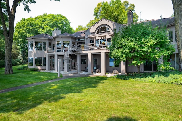 9002 Riley Lake Rd, Eden Prairie, MN 55347 - rear view of house featuring a chimney, a deck, a yard, and stairs