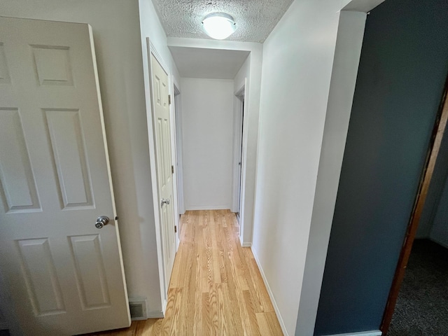 125 1st St, Dresser, WI 54009 - corridor with light wood-style floors and a textured ceiling
