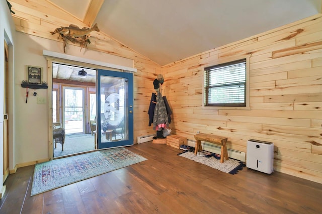 entryway with a baseboard heating unit, hardwood / wood-style floors, lofted ceiling, wooden walls, and healthy amount of natural light