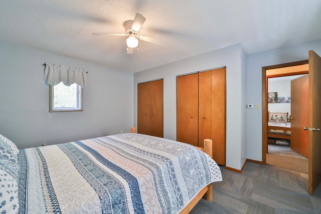 bedroom featuring two closets, carpet, a ceiling fan, and baseboards