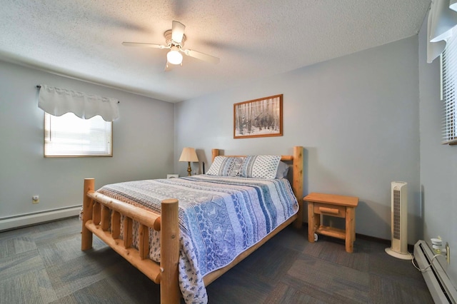 bedroom featuring a baseboard heating unit, a textured ceiling, a ceiling fan, and baseboards