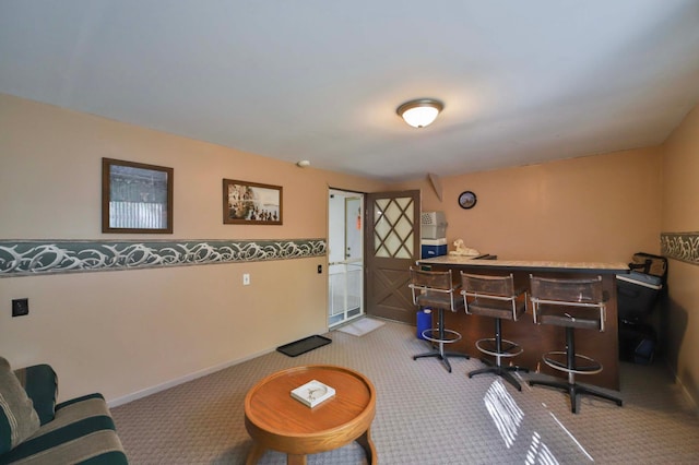 rec room with carpet flooring, a bar, and baseboards