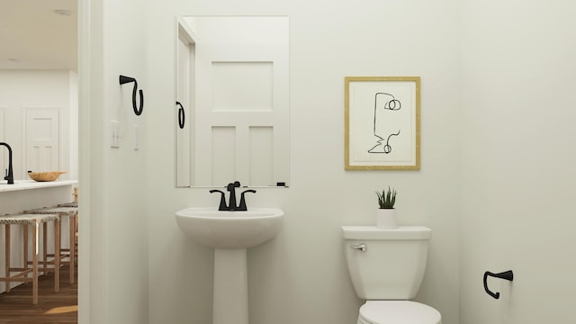 bathroom featuring toilet and wood finished floors
