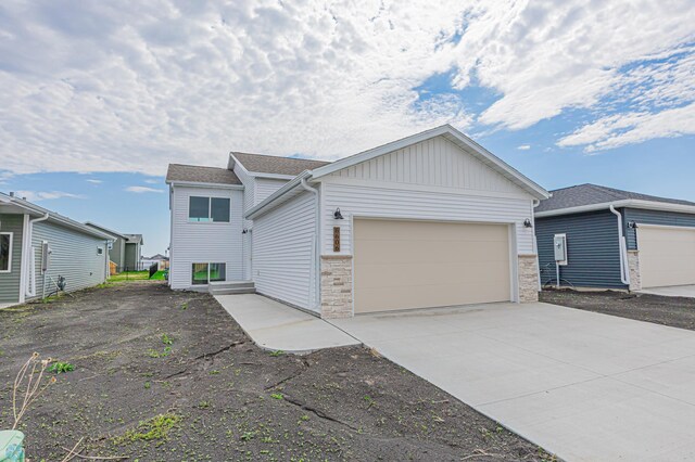 view of front of house featuring a garage, concrete driveway, and board and batten siding