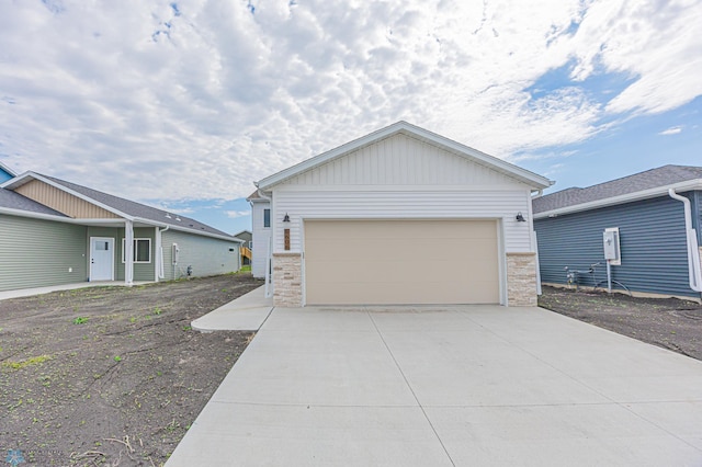 view of front of home with stone siding and concrete driveway