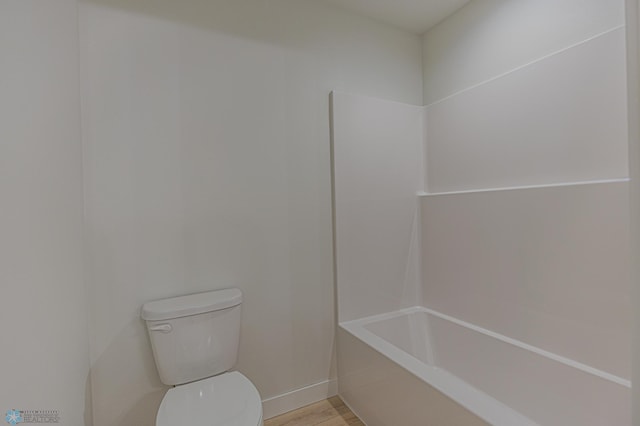 full bath featuring toilet, wood finished floors, and baseboards
