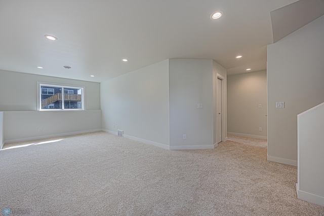unfurnished room with recessed lighting, light carpet, and baseboards