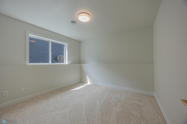 carpeted spare room with baseboards