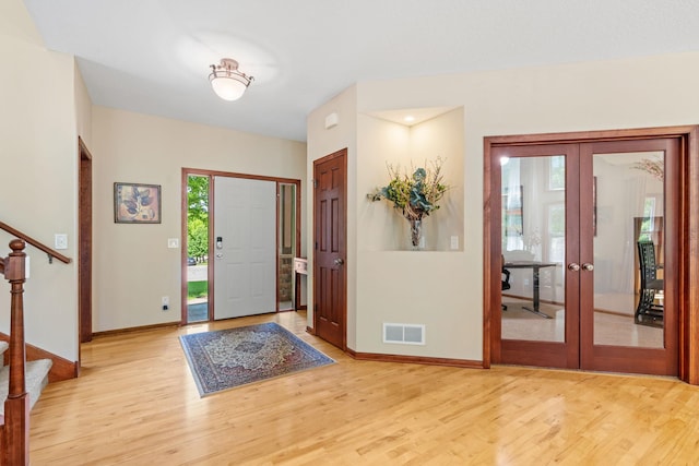 12800 Garrett Ct, Apple Valley, MN 55124 - foyer featuring french doors, stairs, wood finished floors, and baseboards