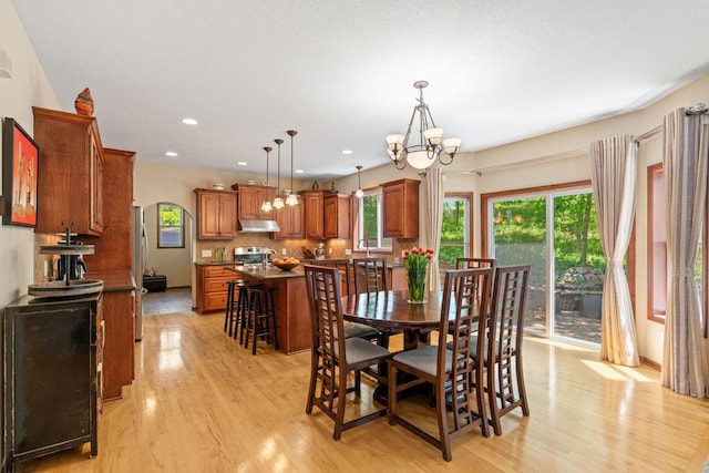 12800 Garrett Ct, Apple Valley, MN 55124 - dining area with a chandelier, light wood-style flooring, healthy amount of natural light, and recessed lighting