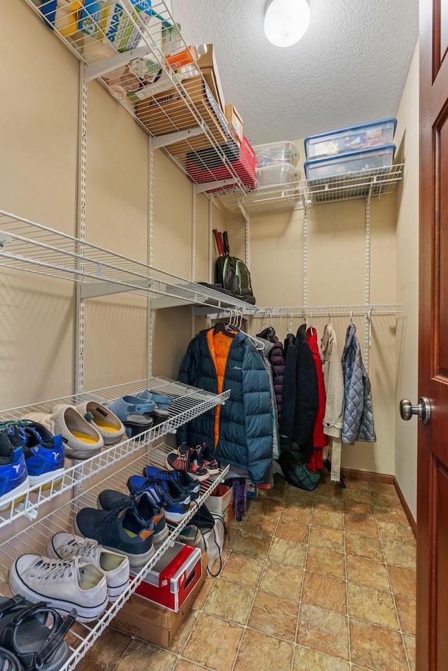 12800 Garrett Ct, Apple Valley, MN 55124 - walk in closet featuring stone finish flooring